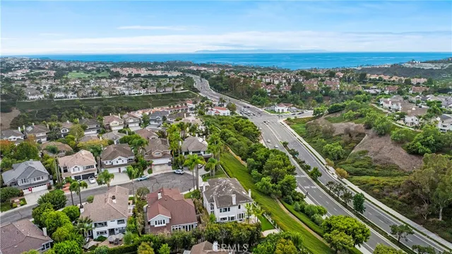 an aerial view of multiple houses with a yard