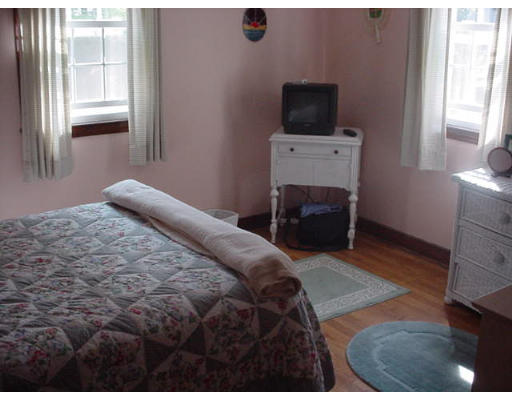 23 Mc Intosh Road Chelmsford, MA 01824 - Photo 8 of 11 a bedroom with a bed and a television