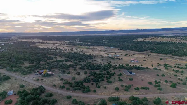 an aerial view of residential house and sandy dunes