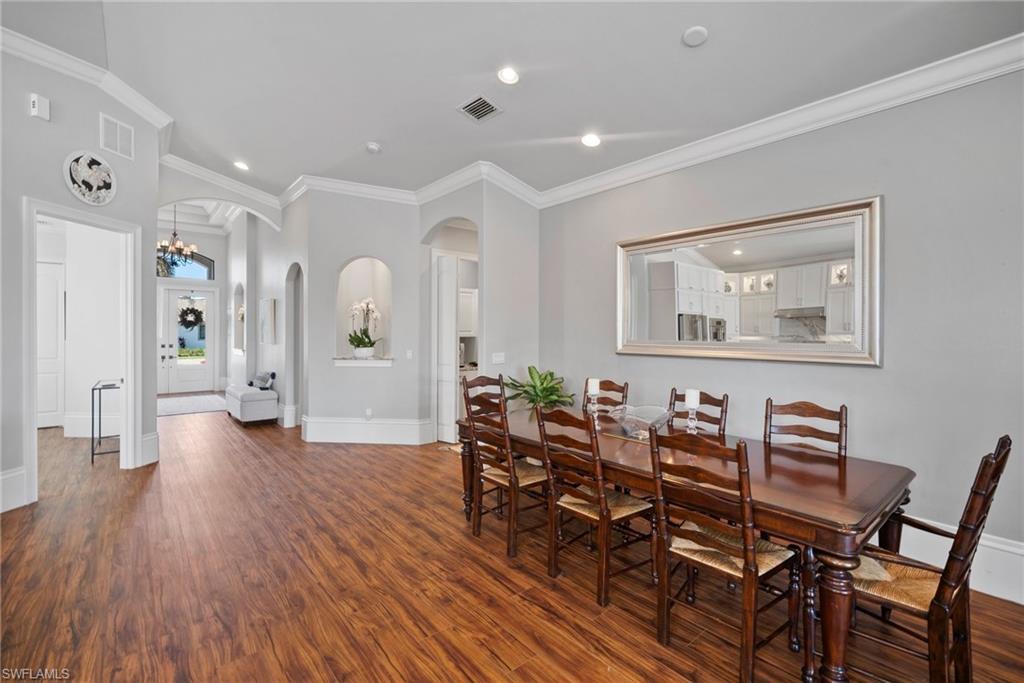 10340 Vanderbilt Drive Naples, FL 34108 - Photo 13 of 45 a living room with furniture and wooden floor