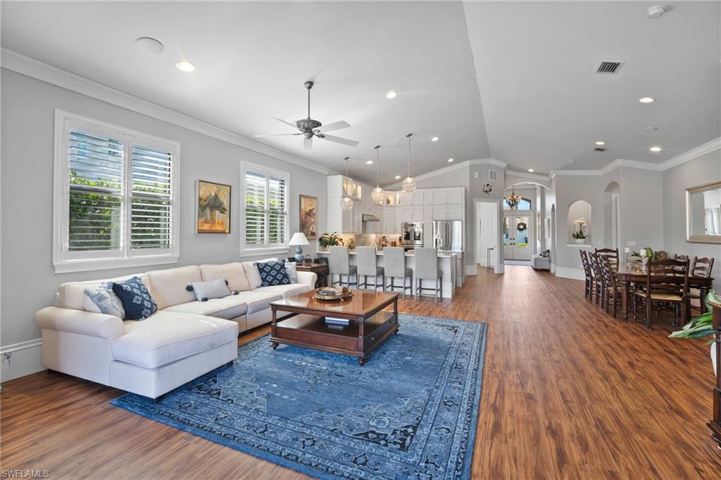 10340 Vanderbilt Drive Naples, FL 34108 - Photo 14 of 45 a living room with furniture and a wooden floor