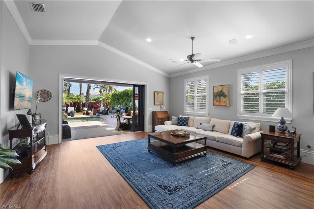 10340 Vanderbilt Drive Naples, FL 34108 - Photo 15 of 45 a living room with furniture and a large window