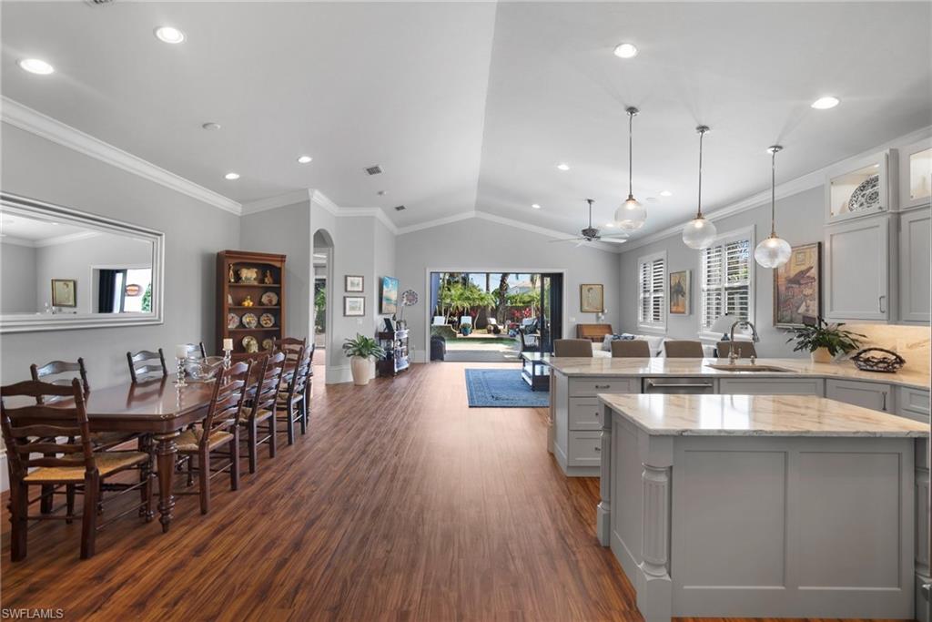 10340 Vanderbilt Drive Naples, FL 34108 - Photo 17 of 45 a kitchen with lots of counter top space and painting on the wall