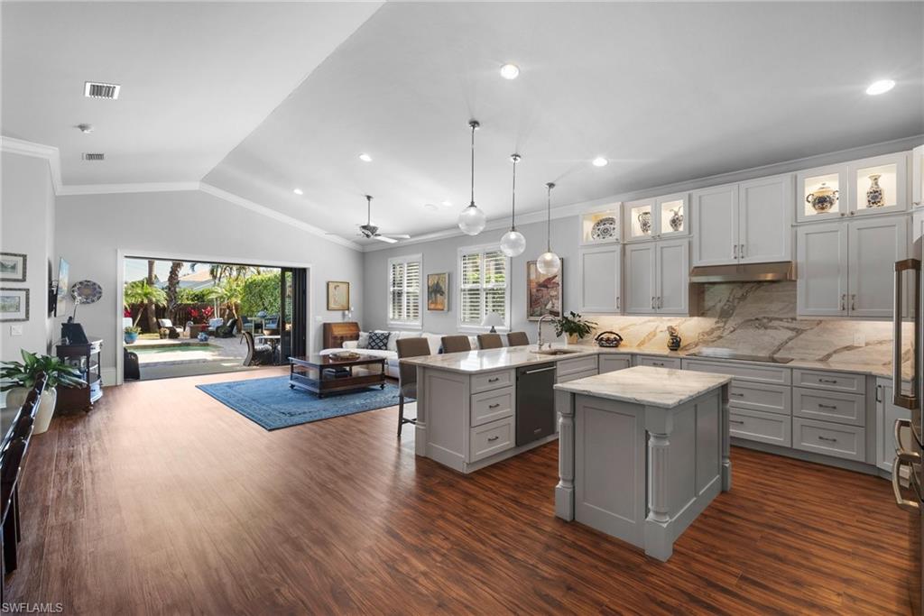 10340 Vanderbilt Drive Naples, FL 34108 - Photo 19 of 45 a kitchen with sink and wooden floor