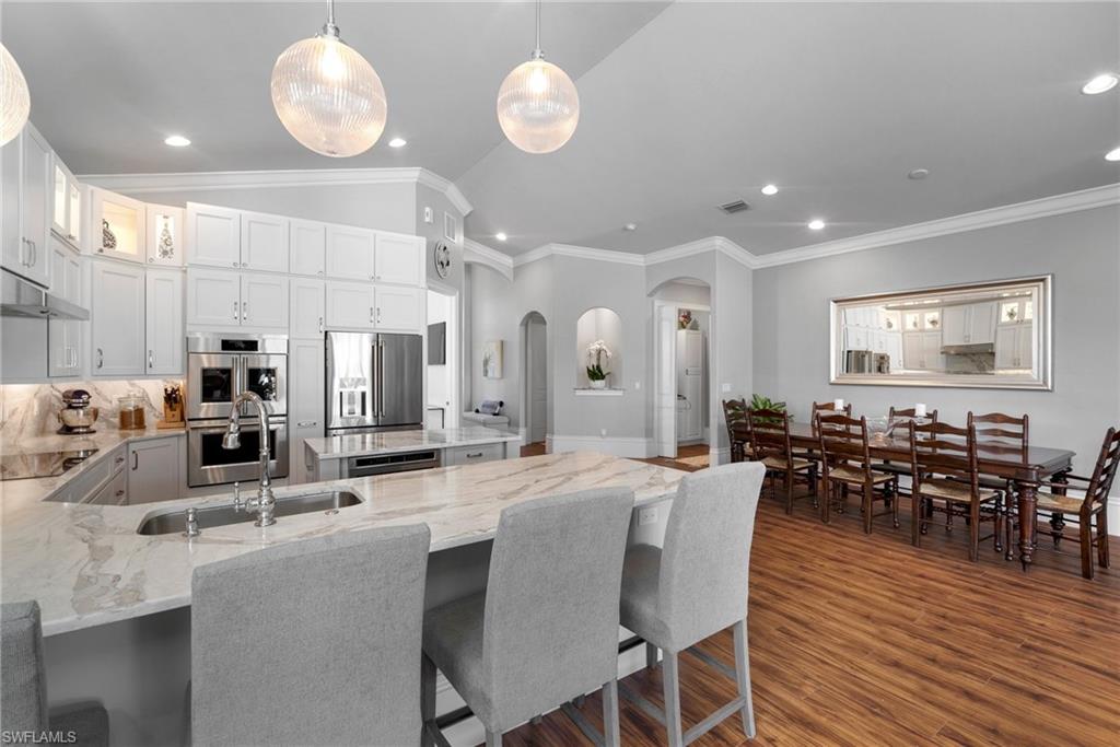 10340 Vanderbilt Drive Naples, FL 34108 - Photo 20 of 45 a large kitchen with a table and chairs