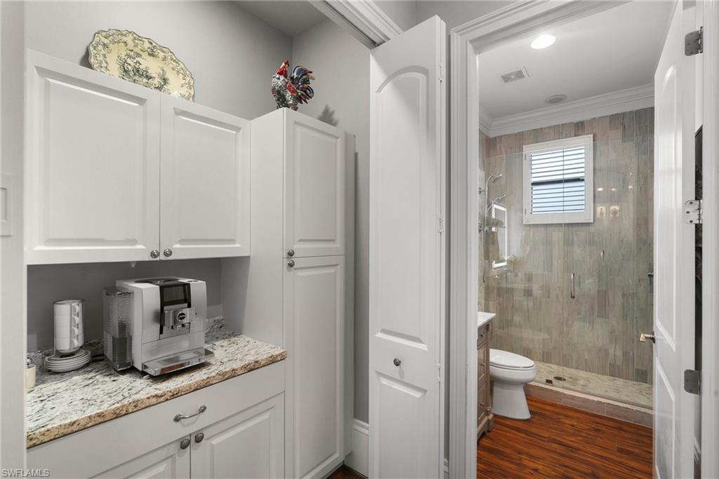 10340 Vanderbilt Drive Naples, FL 34108 - Photo 25 of 45 a bathroom with a granite countertop sink toilet and shower