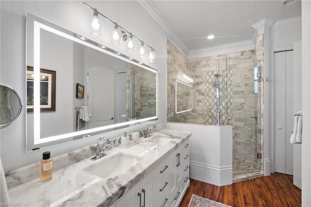 10340 Vanderbilt Drive Naples, FL 34108 - Photo 28 of 45 a bathroom with a double vanity sink mirror and shower