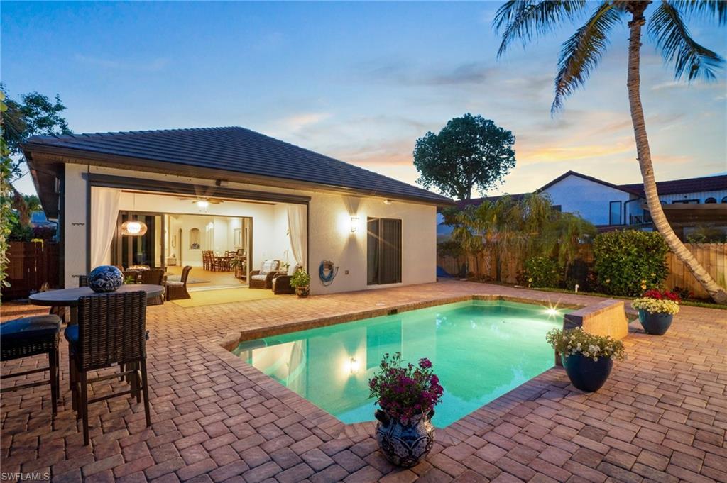 10340 Vanderbilt Drive Naples, FL 34108 - Photo 3 of 45 a view of a house with swimming pool and sitting area