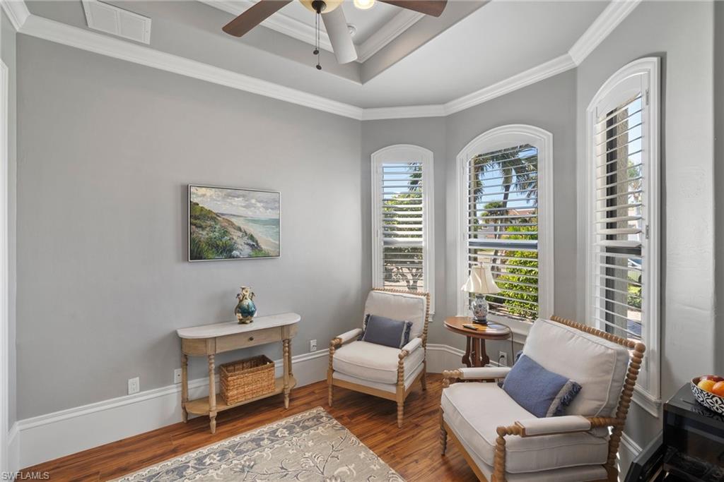 10340 Vanderbilt Drive Naples, FL 34108 - Photo 31 of 45 a living room with furniture and a window