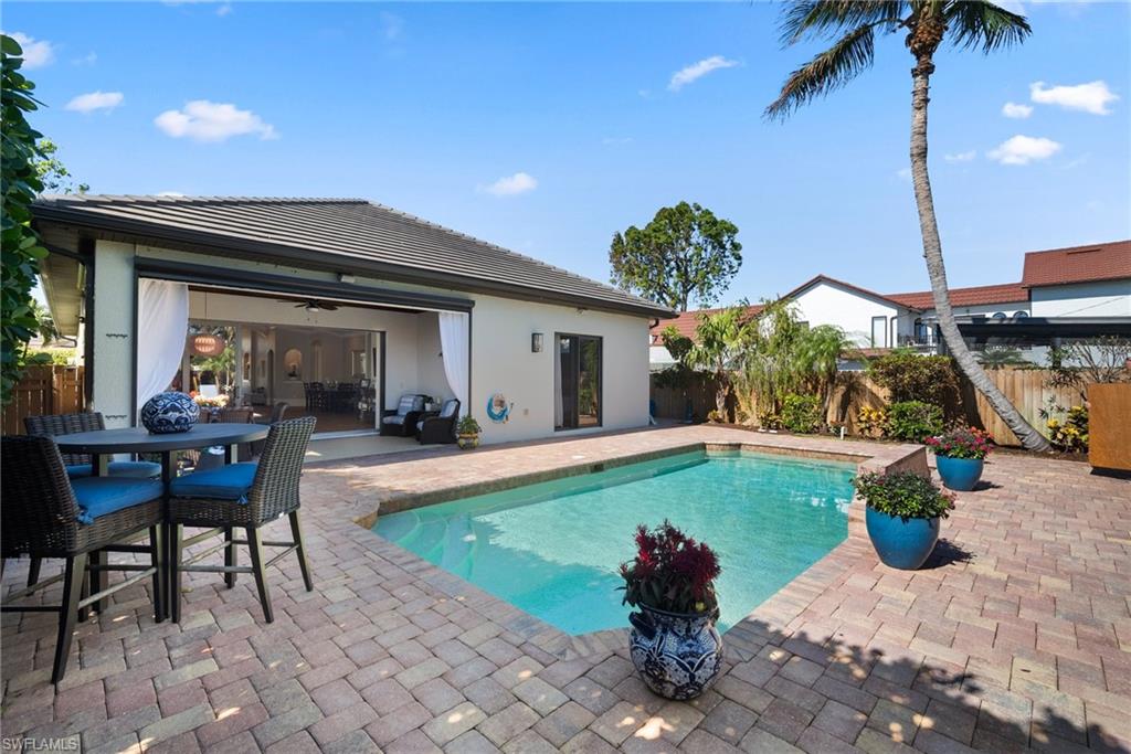 10340 Vanderbilt Drive Naples, FL 34108 - Photo 36 of 45 a view of a house with backyard porch and furniture