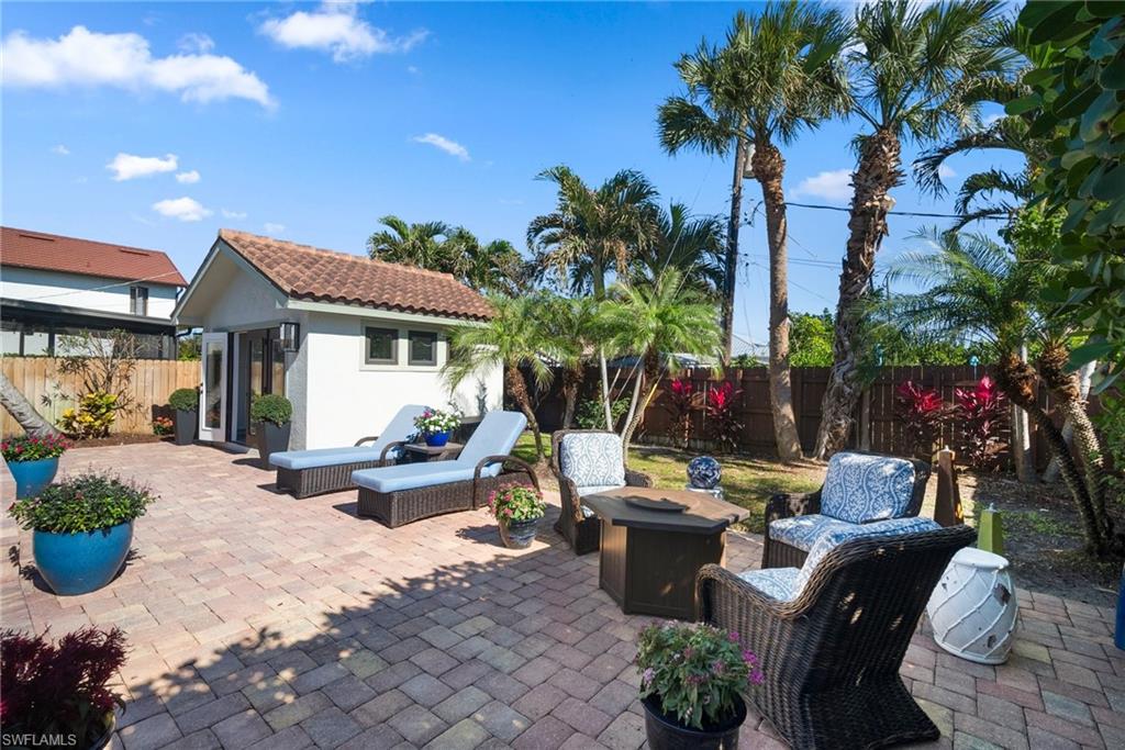 10340 Vanderbilt Drive Naples, FL 34108 - Photo 37 of 45 a view of a house with backyard sitting area and swimming pool