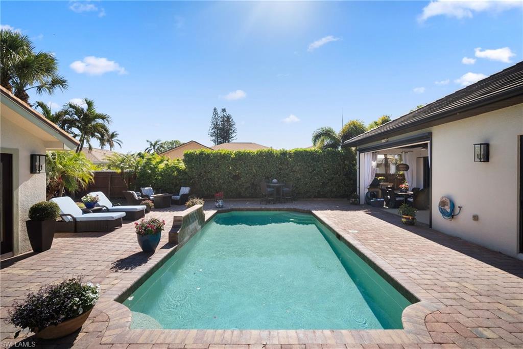 10340 Vanderbilt Drive Naples, FL 34108 - Photo 38 of 45 a view of outdoor space yard deck patio and outdoor kitchen