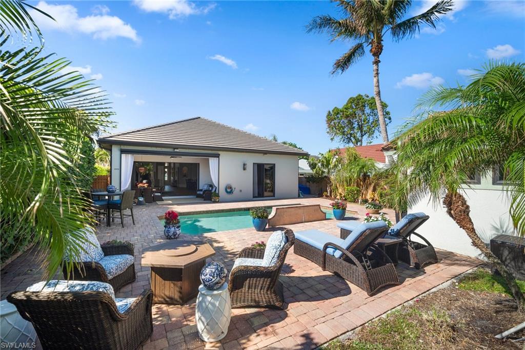 10340 Vanderbilt Drive Naples, FL 34108 - Photo 39 of 45 a view of backyard of house with seating space