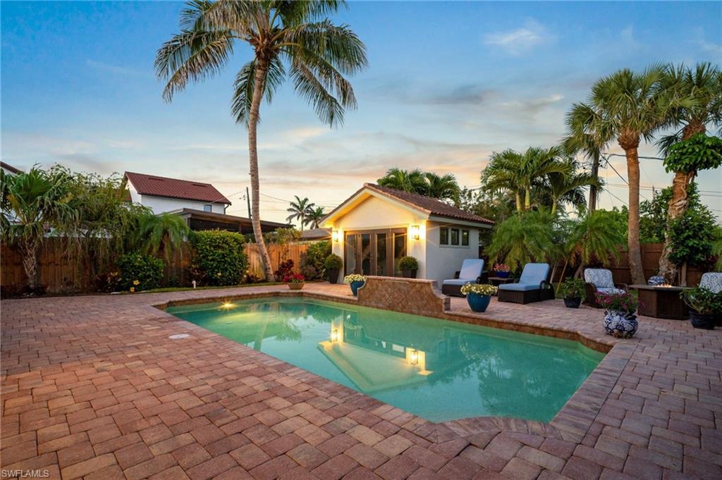 10340 Vanderbilt Drive Naples, FL 34108 - Photo 4 of 45 a view of a swimming pool with chairs in patio