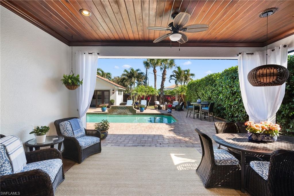 10340 Vanderbilt Drive Naples, FL 34108 - Photo 42 of 45 a living room with furniture and a large window