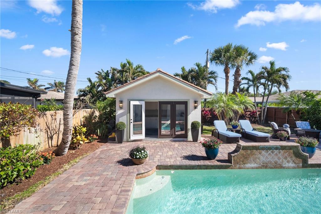 10340 Vanderbilt Drive Naples, FL 34108 - Photo 43 of 45 a view of a house with backyard sitting area and garden