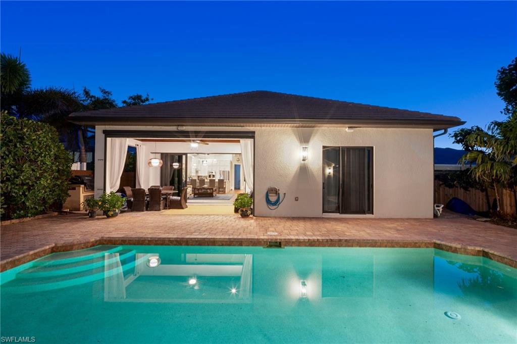 10340 Vanderbilt Drive Naples, FL 34108 - Photo 6 of 45 a front view of a house with yard