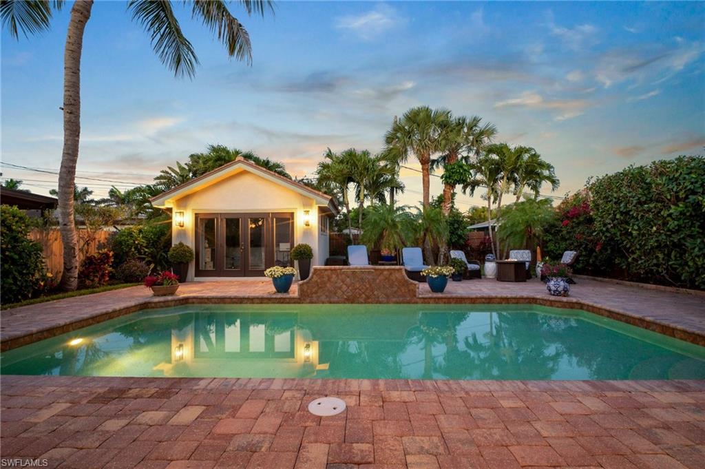 10340 Vanderbilt Drive Naples, FL 34108 - Photo 9 of 45 a view of a house with swimming pool and sitting area