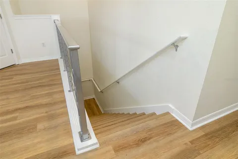 a view of entryway and hall with wooden floor