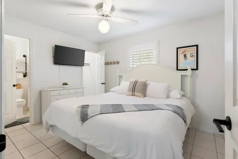 a bedroom with a bed and a flat screen tv