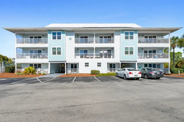 a view of building with cars parked in front of it