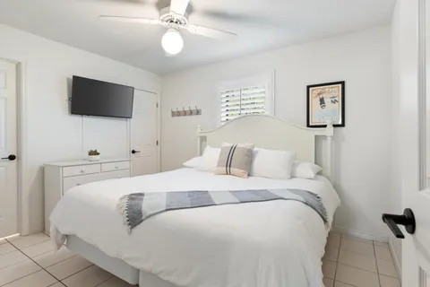 a bedroom with a bed and a flat screen tv