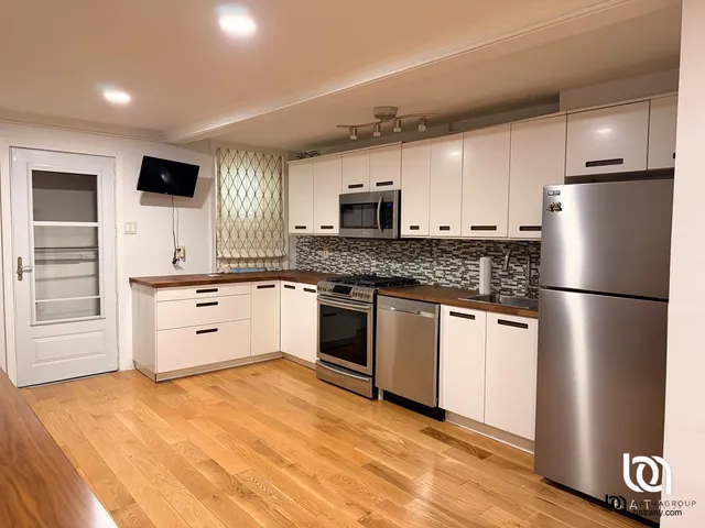 a kitchen with stainless steel appliances a refrigerator stove and microwave