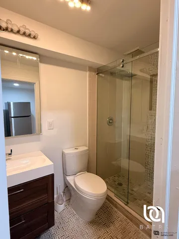 a bathroom with a toilet a sink and shower