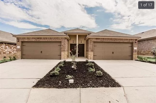 a front view of a house with a garage