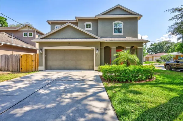 a front view of a house with a yard and garage