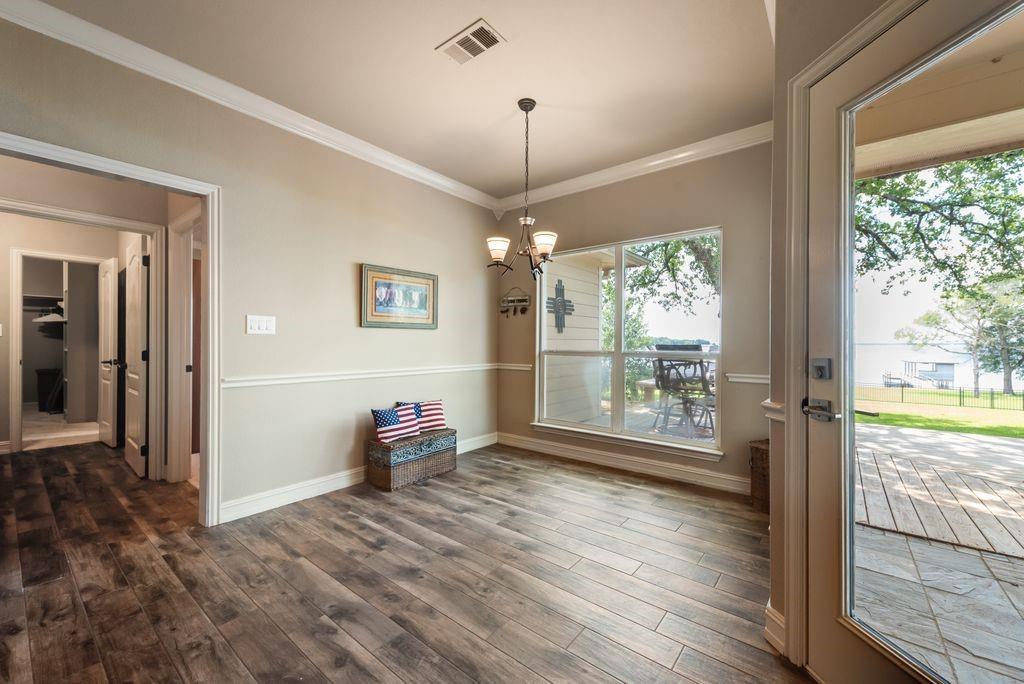 13026 Rudy's Way Streetman, TX 75859 - Photo 15 of 40 This dining room area offers up meals with a view and quick access to the back deck!