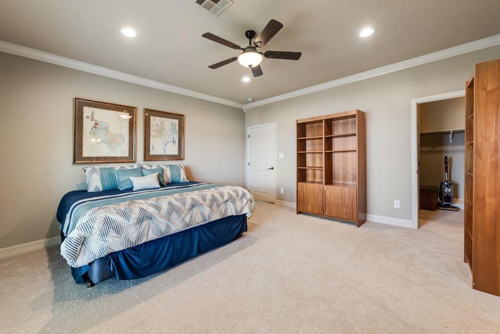 13026 Rudy's Way Streetman, TX 75859 - Photo 16 of 40 a spacious bedroom with a large bed and ceiling fan