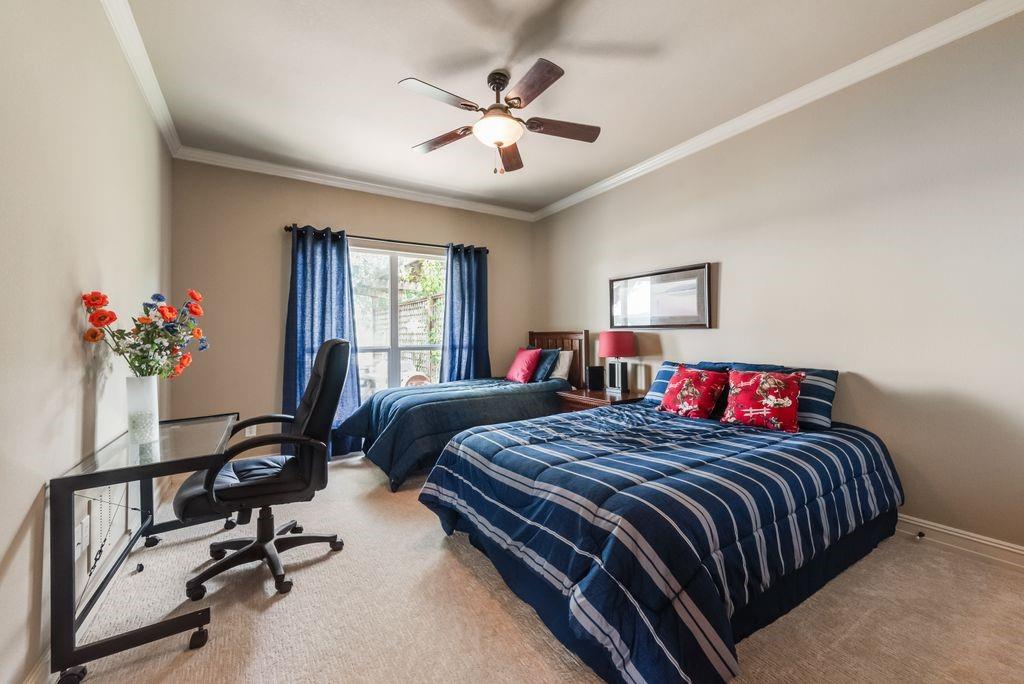 13026 Rudy's Way Streetman, TX 75859 - Photo 23 of 40 a bedroom with a bed and a chandelier