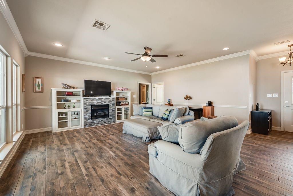 13026 Rudy's Way Streetman, TX 75859 - Photo 9 of 40 a living room with furniture a fireplace and a flat screen tv