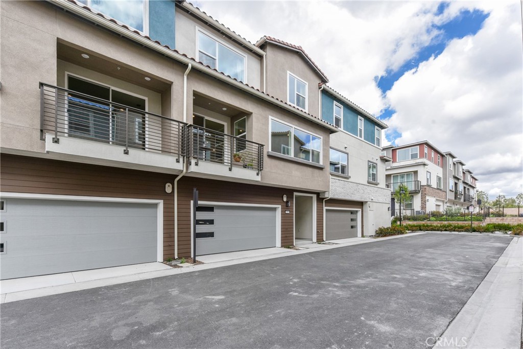224 Siena Lake Forest, CA 92630 - Photo 2 of 46 a front view of a house with a yard and garage