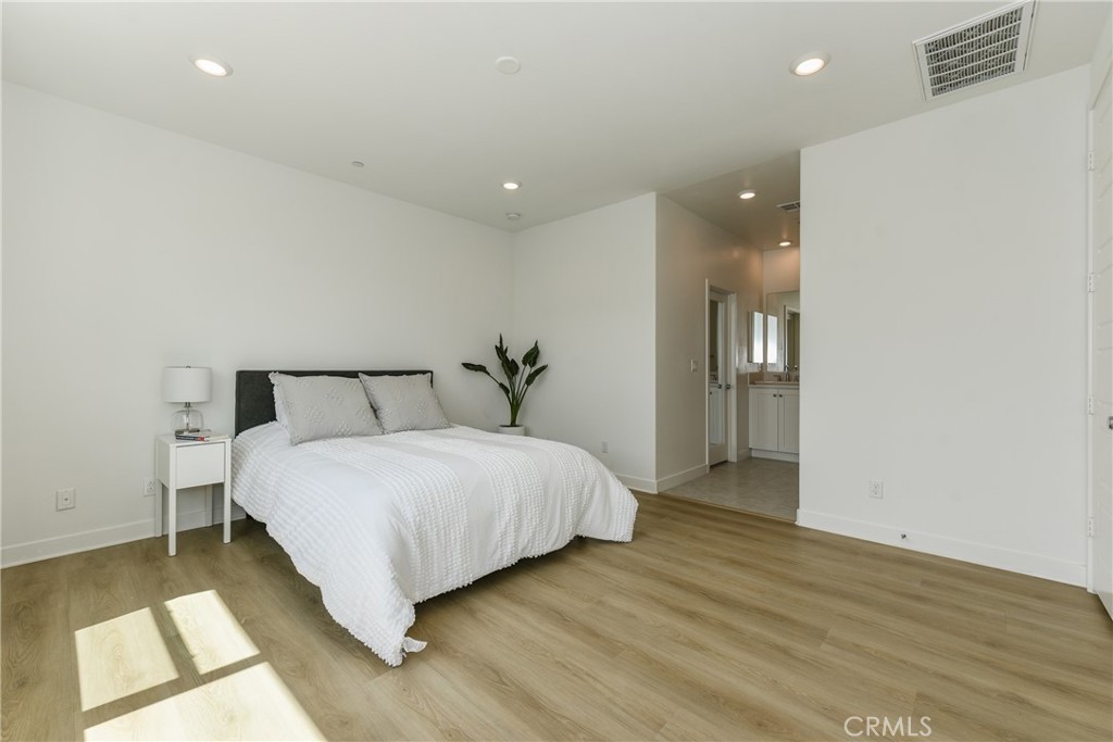 224 Siena Lake Forest, CA 92630 - Photo 23 of 46 a bedroom with a bed and a night stand