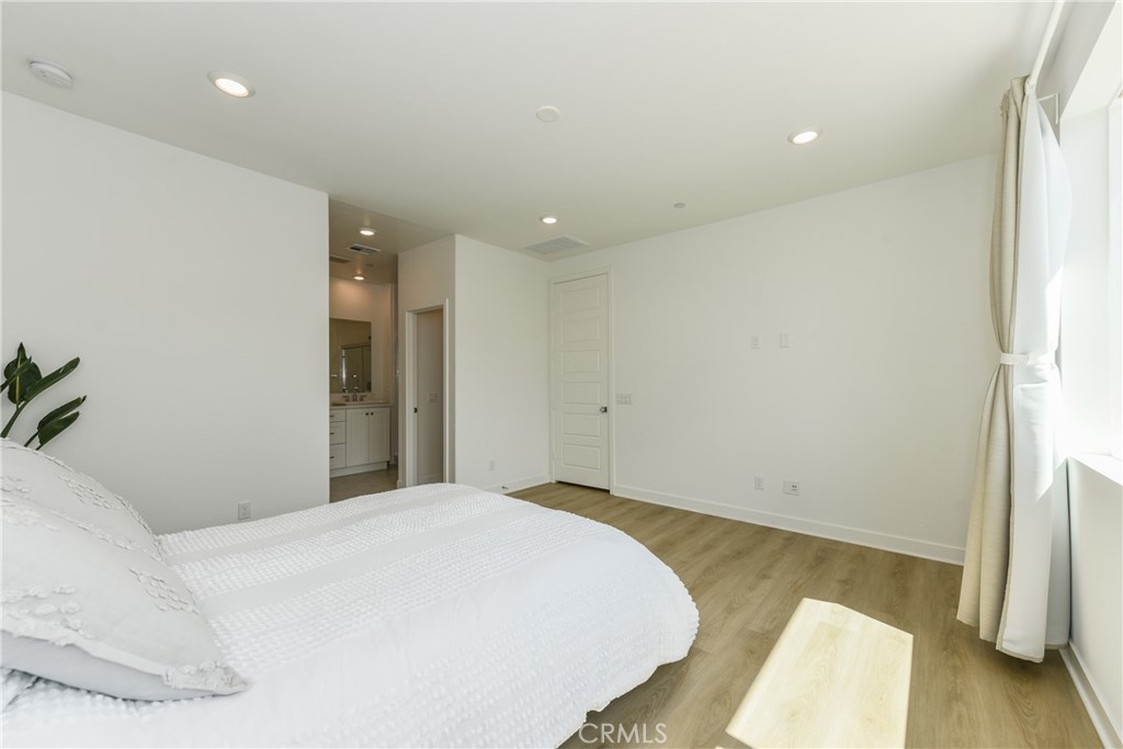 224 Siena Lake Forest, CA 92630 - Photo 24 of 46 a bedroom with a bed and a potted plant