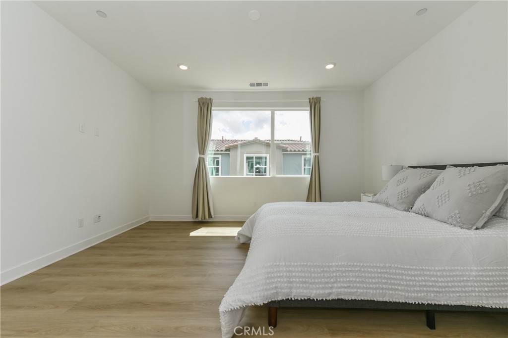 224 Siena Lake Forest, CA 92630 - Photo 25 of 46 a bedroom with a bed and a window