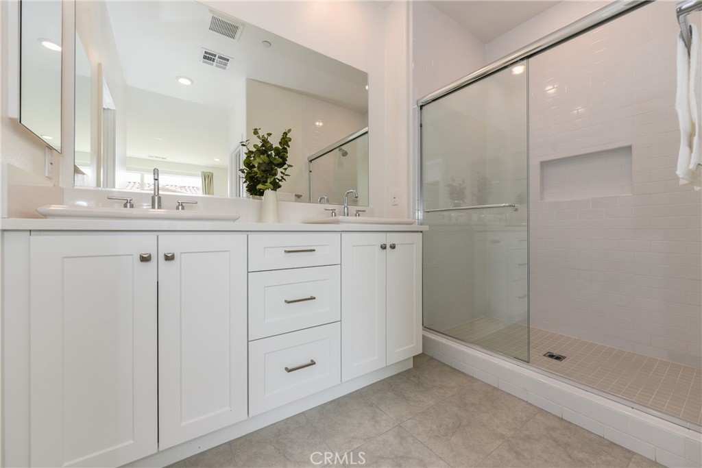 224 Siena Lake Forest, CA 92630 - Photo 26 of 46 a bathroom with a shower sink and mirror
