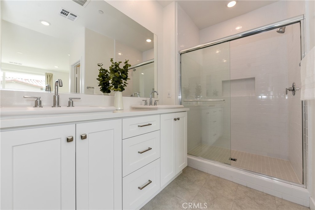224 Siena Lake Forest, CA 92630 - Photo 27 of 46 a bathroom with a shower sink and mirror