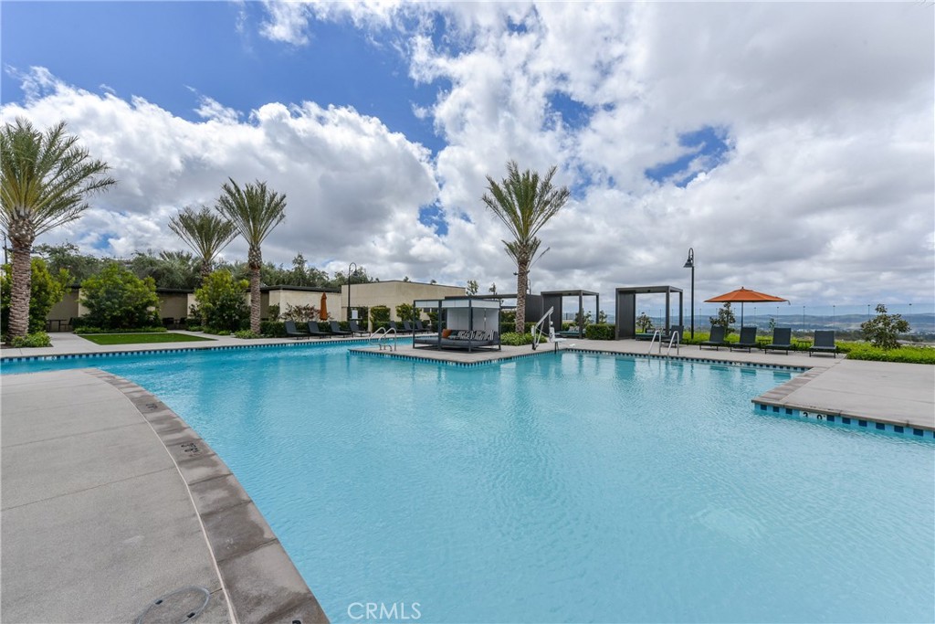224 Siena Lake Forest, CA 92630 - Photo 37 of 46 a view of a swimming pool next to a lake with houses in the back