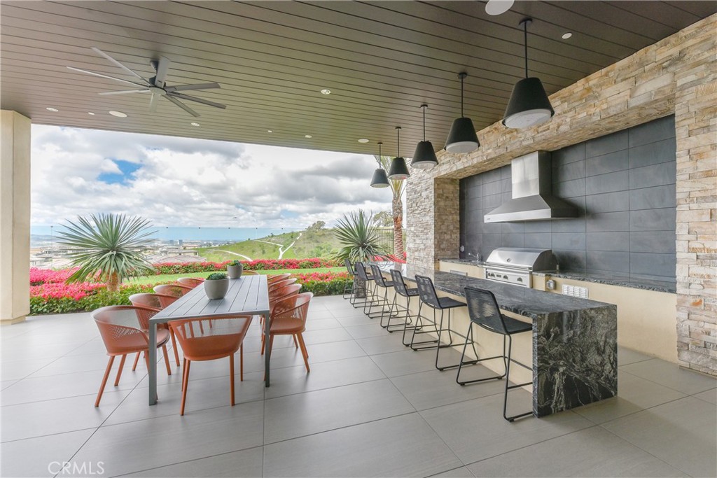 224 Siena Lake Forest, CA 92630 - Photo 43 of 46 a view of a patio with a dining table and chairs with wooden floor