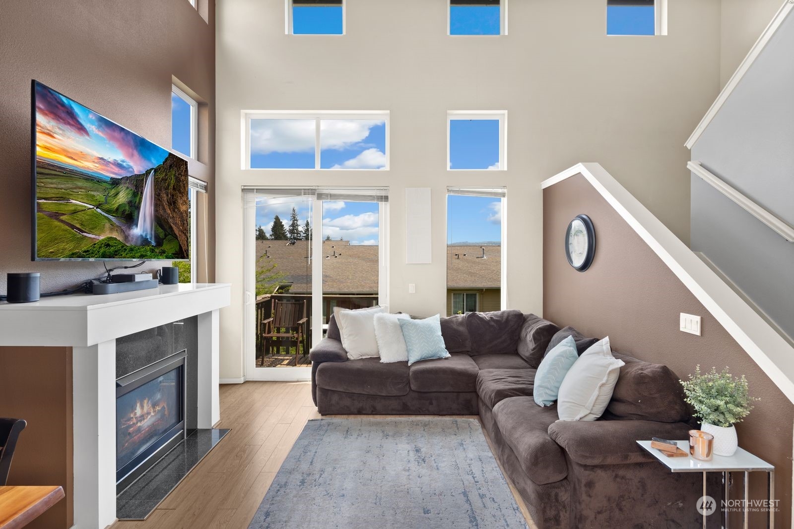 124 Sky Ridge Road Northwest Issaquah, WA 98027 - Photo 4 of 40 a living room with furniture a flat screen tv and a fireplace