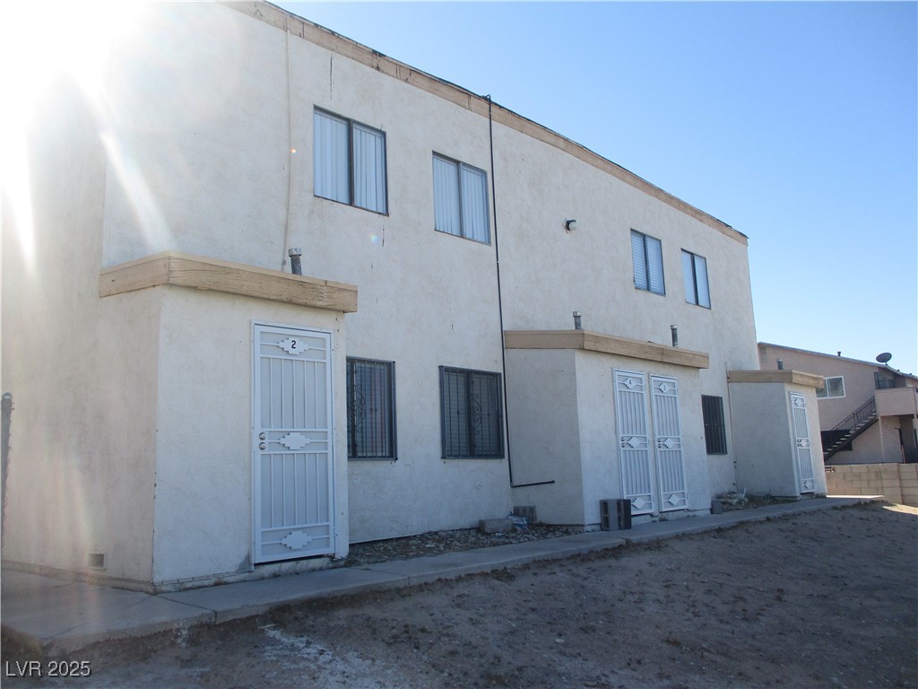 2377 Exeter Drive, Unit 3 Las Vegas, NV 89156 - Photo 2 of 13 Rear view of house featuring stucco siding