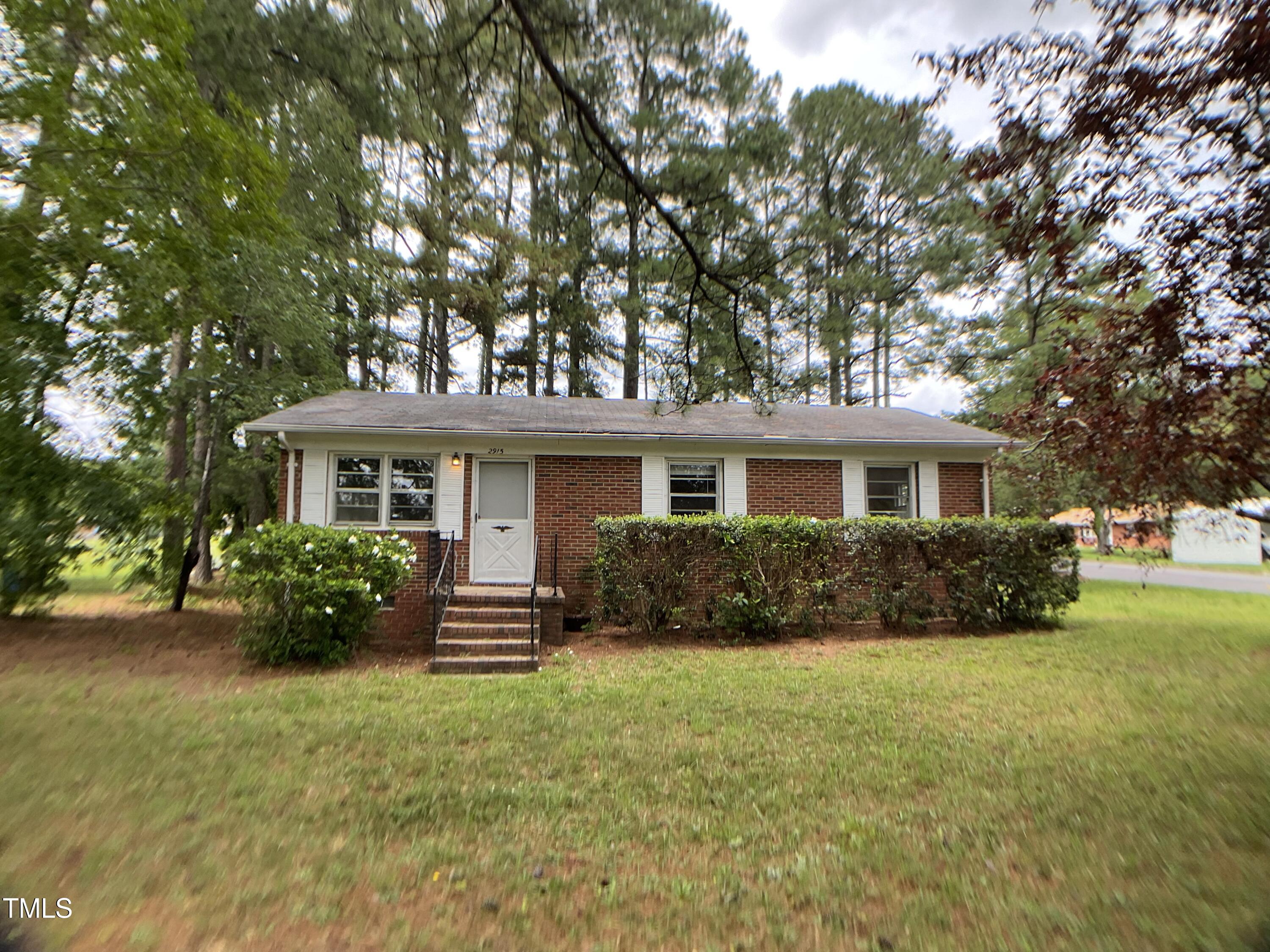 2915 Ross Road Durham, NC 27703 - Photo 1 of 21 a front view of a house with a garden
