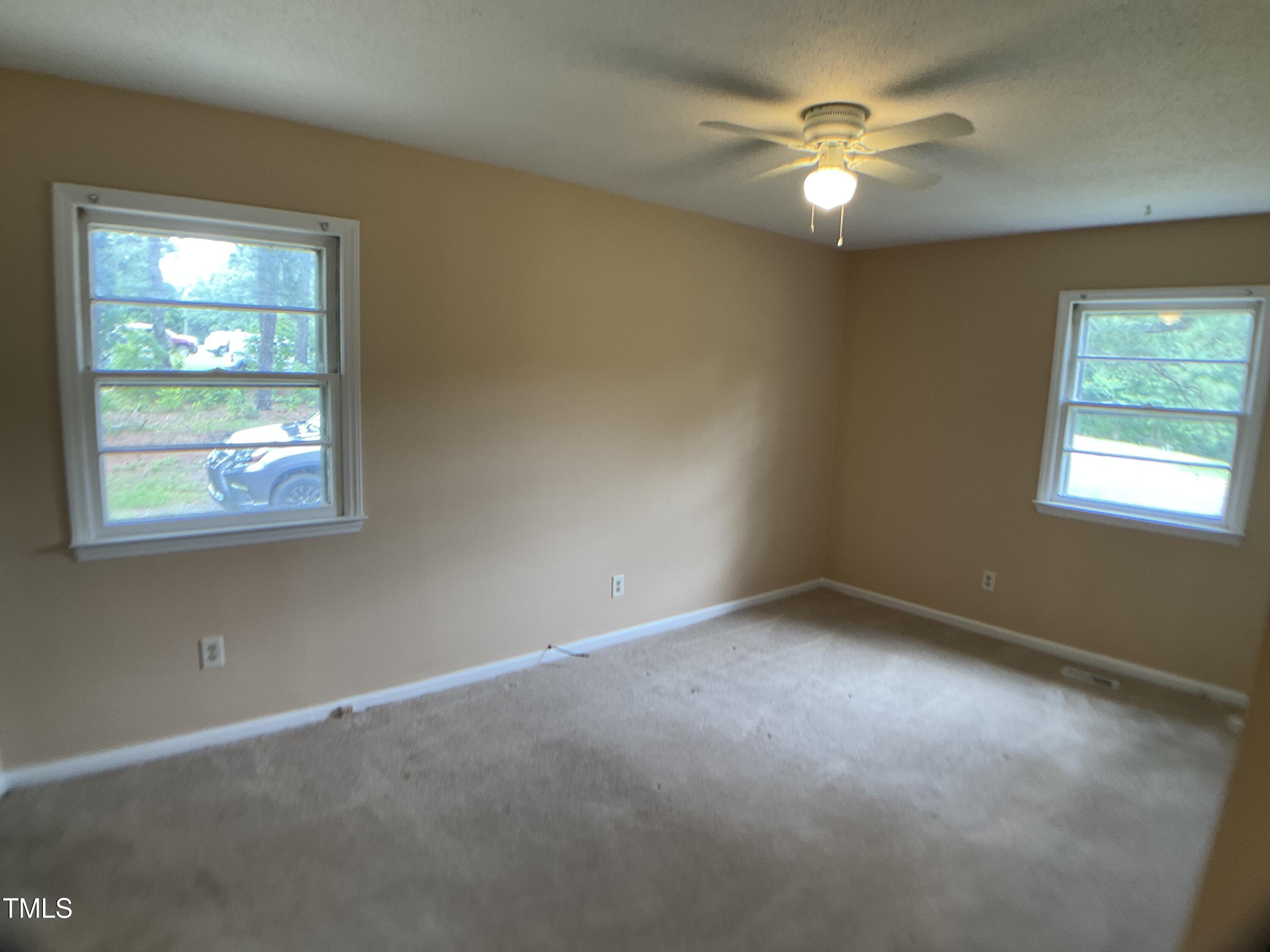 2915 Ross Road Durham, NC 27703 - Photo 12 of 21 an empty room with windows and fan