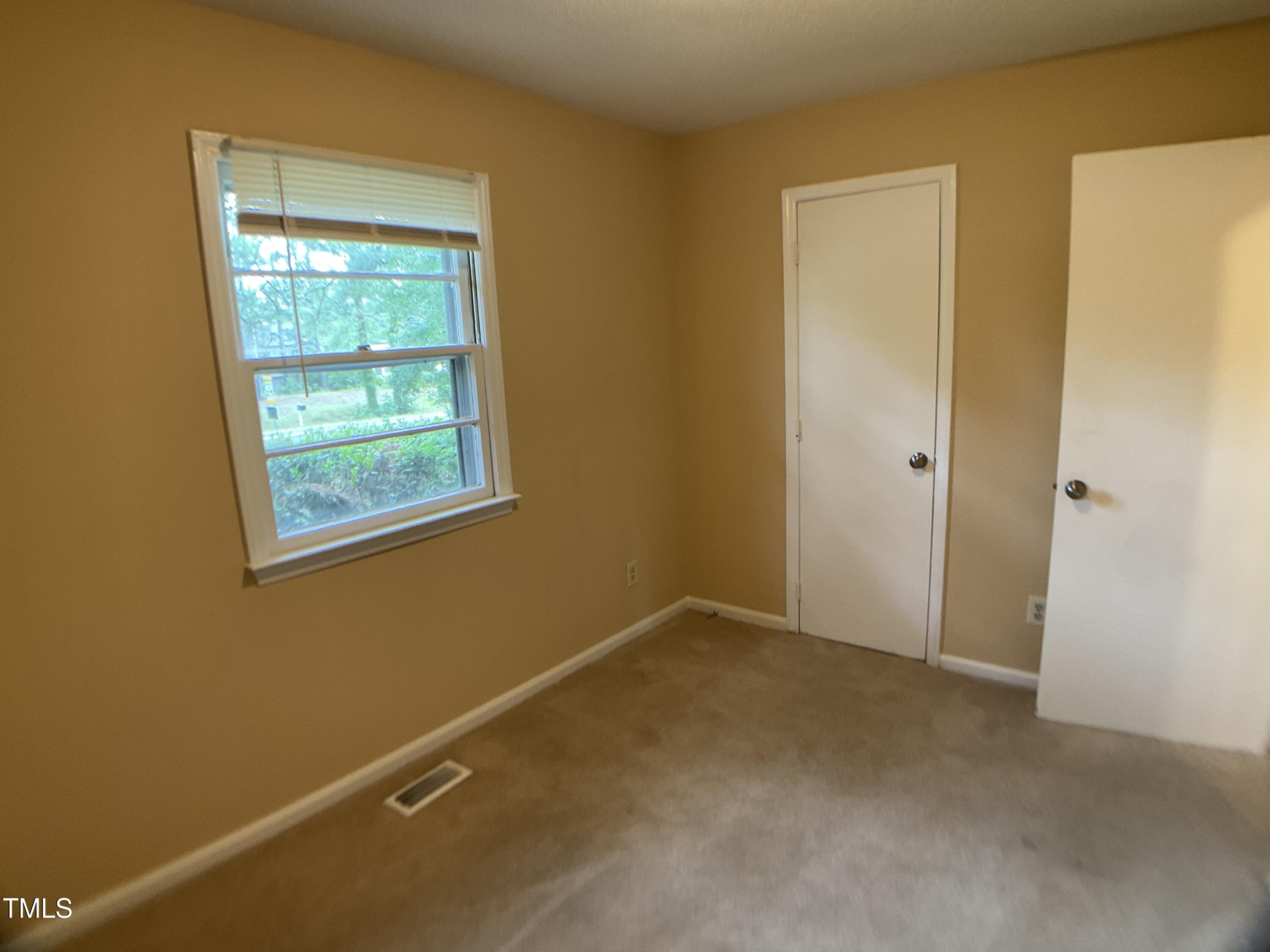 2915 Ross Road Durham, NC 27703 - Photo 14 of 21 a view of an empty room with a window