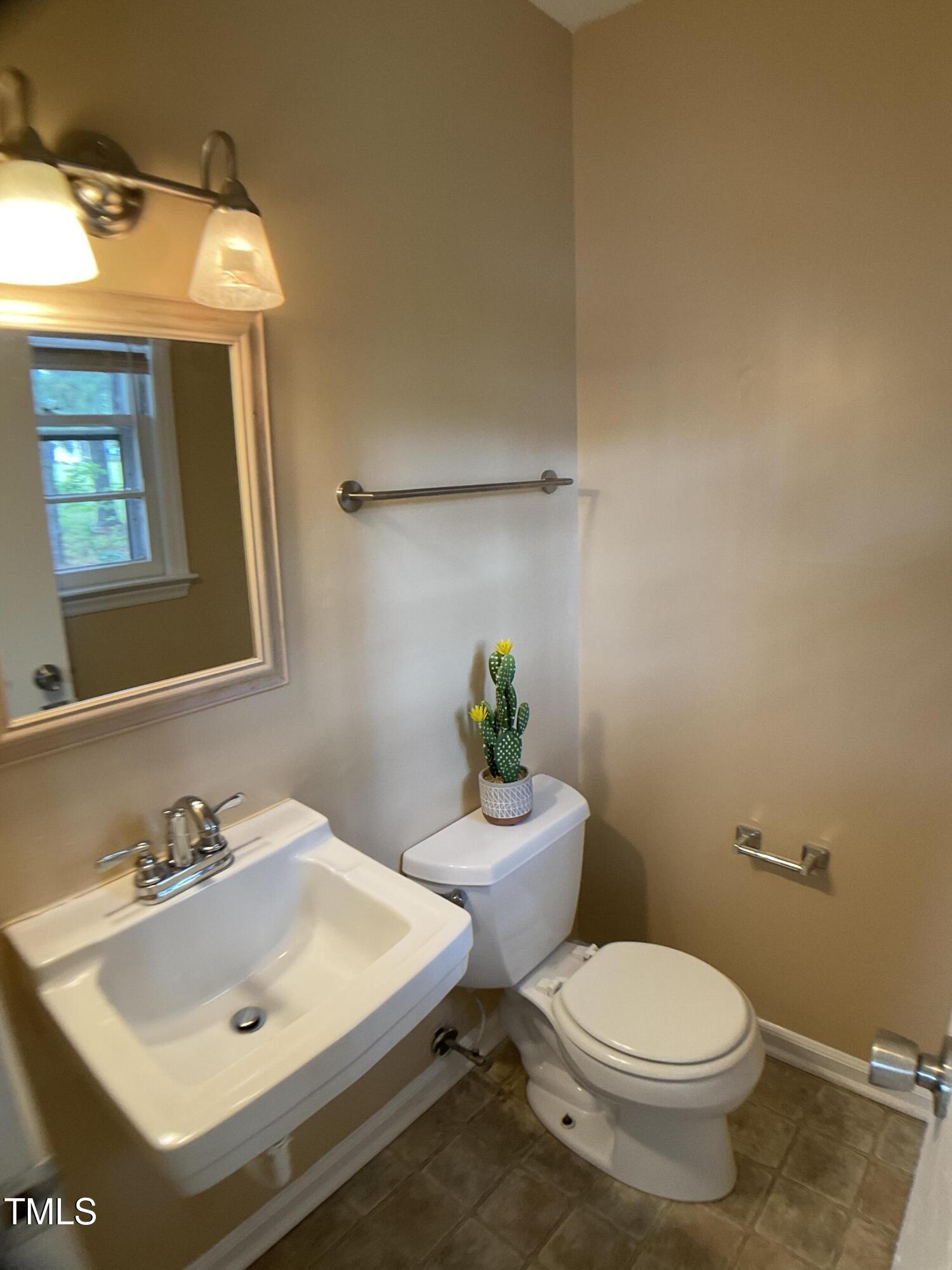 2915 Ross Road Durham, NC 27703 - Photo 15 of 21 a bathroom with a sink mirror and toilet
