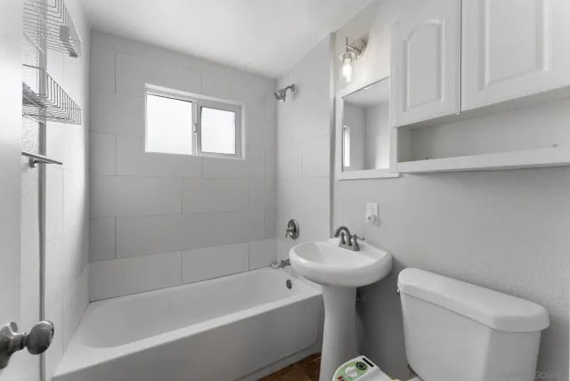 a bathroom with a sink a toilet and bathtub
