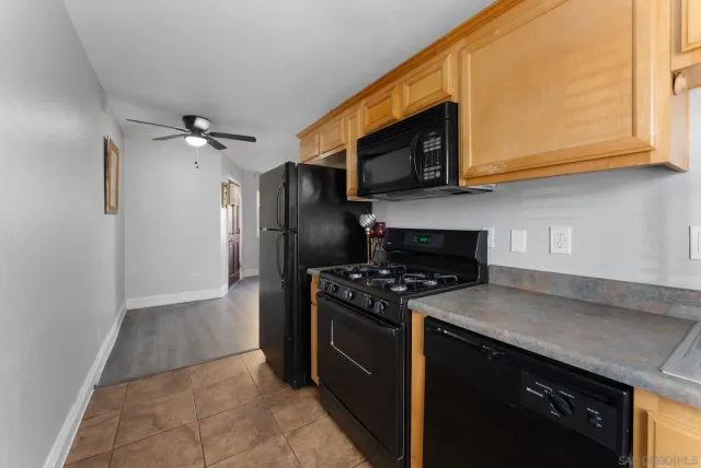 a kitchen with stainless steel appliances granite countertop a stove a refrigerator and a microwave